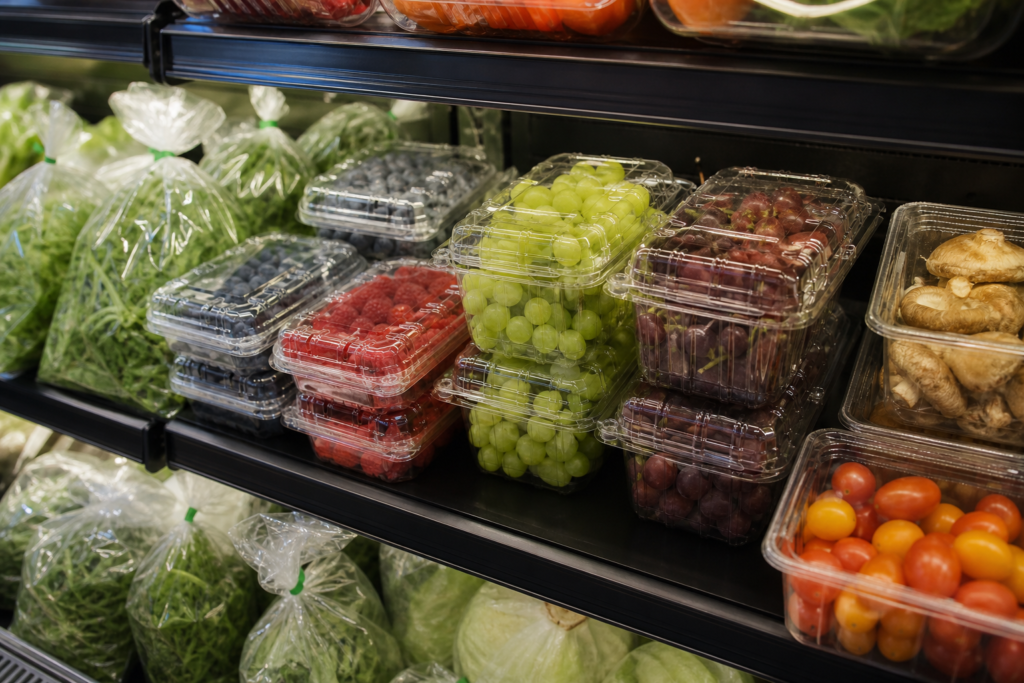 Plastic produce clamshell boxes and bags used in a supermarket produce display